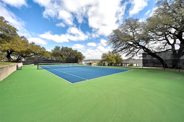 view of sport court featuring fence