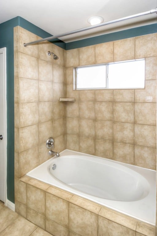 bathroom with tile patterned flooring and tiled shower / bath combo