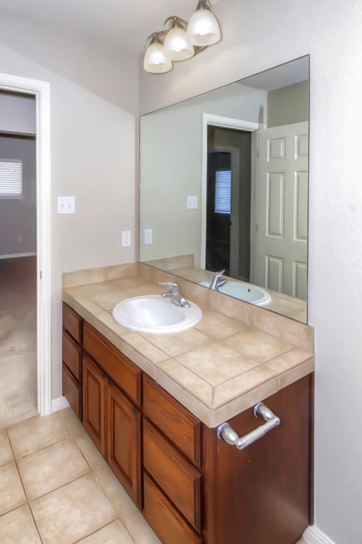 bathroom with tile patterned floors and vanity