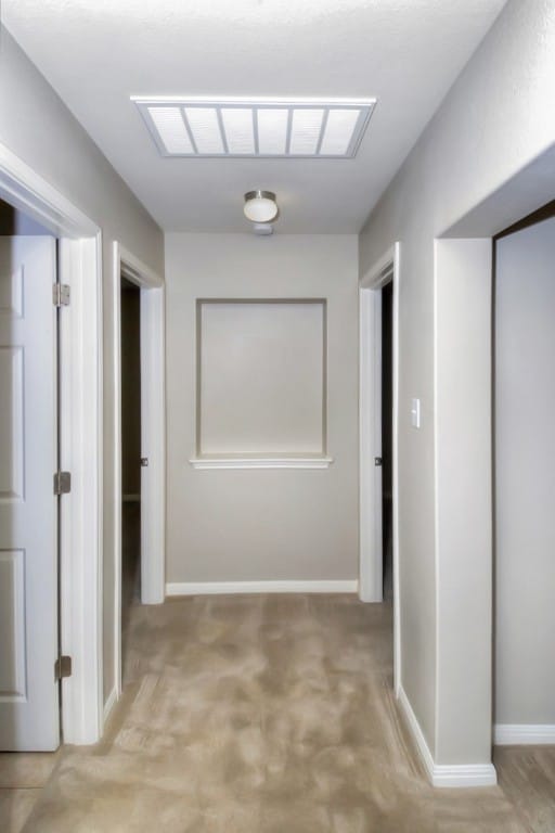 corridor featuring visible vents and baseboards