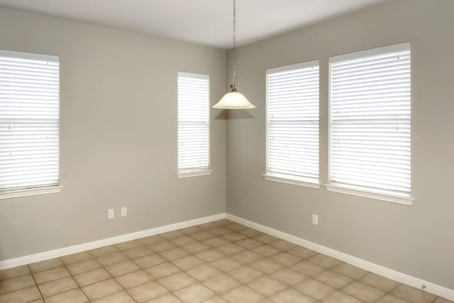 unfurnished room with baseboards