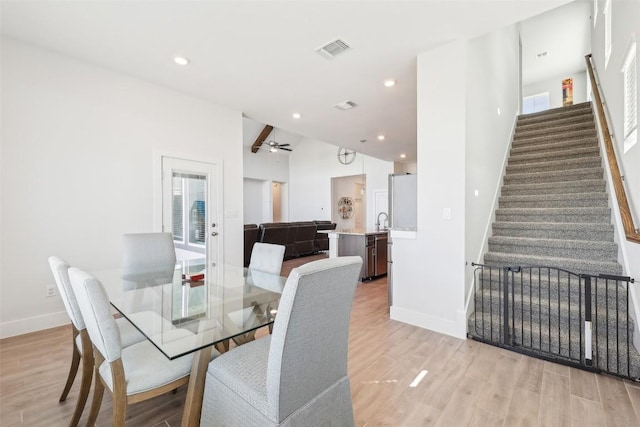 dining room featuring visible vents, recessed lighting, stairway, and light wood-style floors