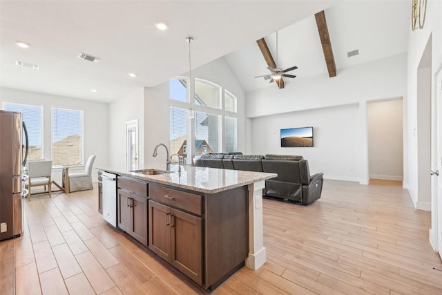 kitchen with visible vents, light wood-style flooring, appliances with stainless steel finishes, and a sink