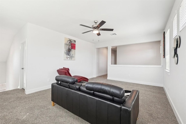 carpeted living area with a ceiling fan, a healthy amount of sunlight, visible vents, and baseboards