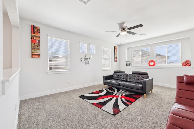 carpeted living room with baseboards, plenty of natural light, visible vents, and ceiling fan