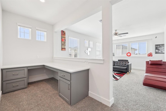 office space with carpet flooring, baseboards, plenty of natural light, and built in study area