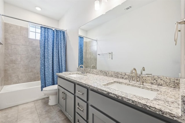 full bathroom featuring toilet, visible vents, shower / tub combo with curtain, and a sink