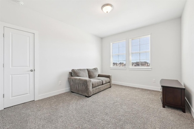 sitting room with carpet and baseboards