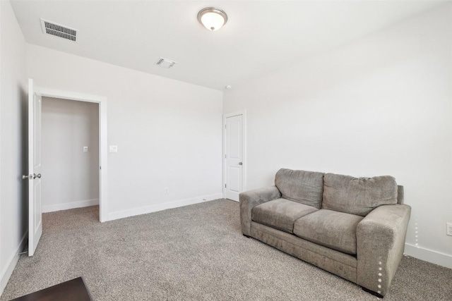 sitting room featuring visible vents, carpet floors, and baseboards