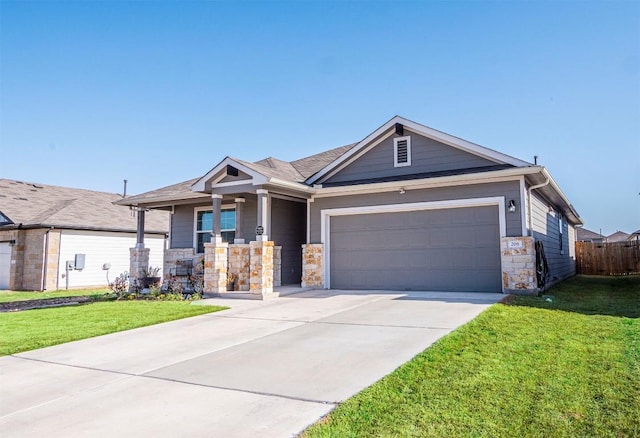 view of front of home with a garage, concrete driveway, a front lawn, and stone siding