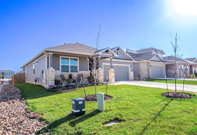 view of front of home featuring fence, an attached garage, concrete driveway, a front lawn, and stone siding