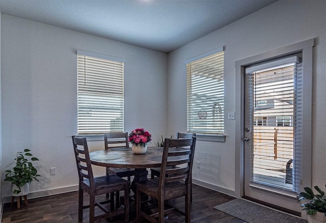 dining room featuring baseboards and dark wood-style flooring