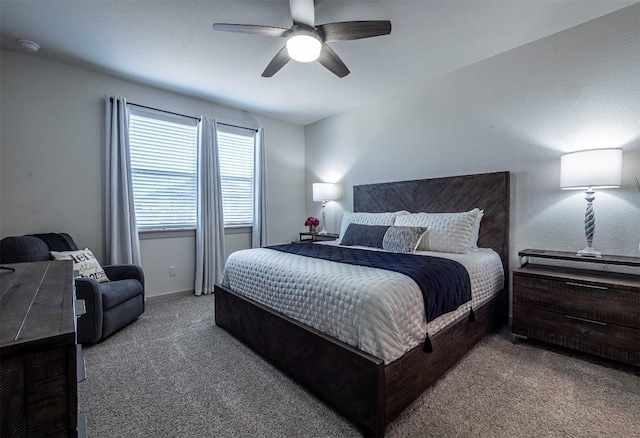 carpeted bedroom featuring a ceiling fan and baseboards