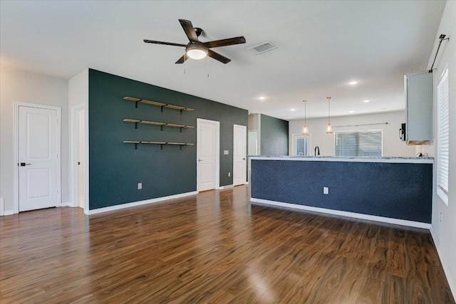 300 Eagle Lake Dr, Hutto, TX 78634 - unfurnished living room featuring a ceiling fan, dark wood finished floors, and recessed lighting