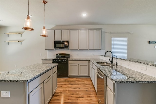 300 Eagle Lake Dr, Hutto, TX 78634 - kitchen featuring black appliances, gray cabinetry, a peninsula, and recessed lighting