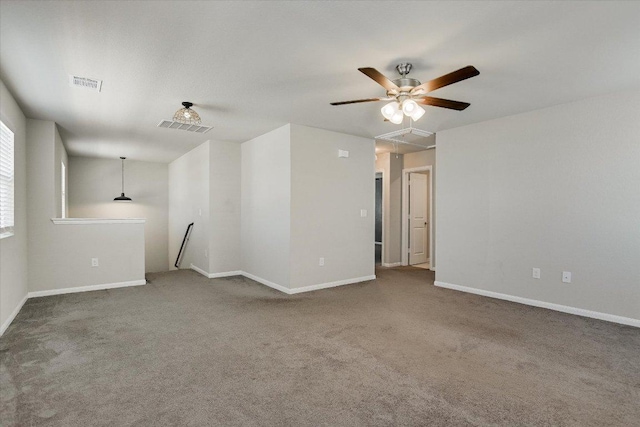 empty room with carpet, ceiling fan, and baseboards