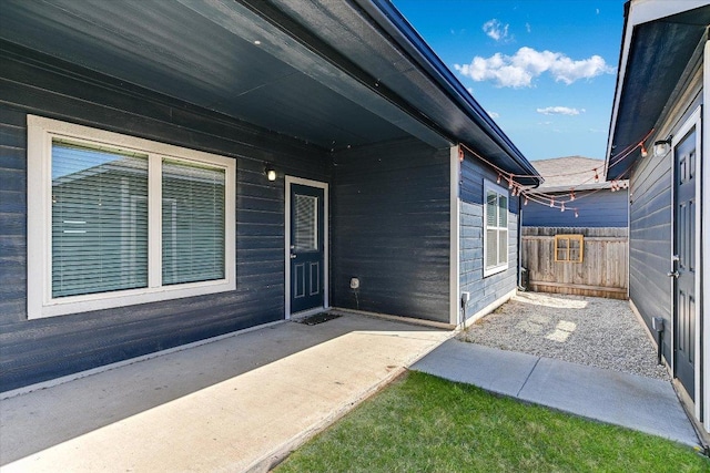 entrance to property with a patio and fence