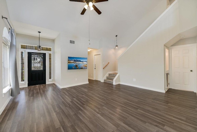 entrance foyer featuring a towering ceiling, ceiling fan, and dark wood-style flooring