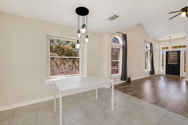 foyer entrance with visible vents, baseboards, ceiling fan, and tile patterned flooring