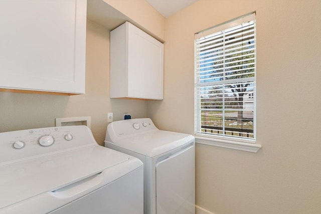 laundry area featuring cabinet space and separate washer and dryer