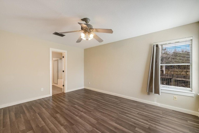 unfurnished room with visible vents, baseboards, wood finished floors, and a ceiling fan