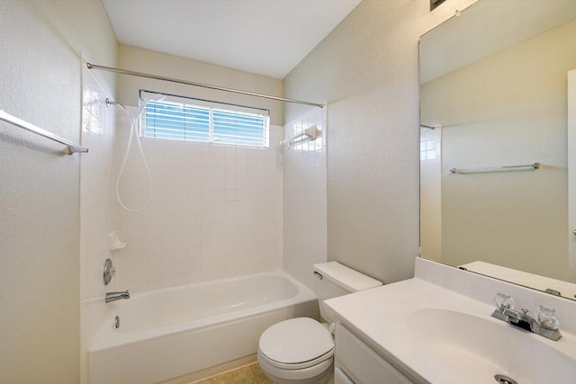 bathroom featuring vanity, bathing tub / shower combination, toilet, and a textured wall