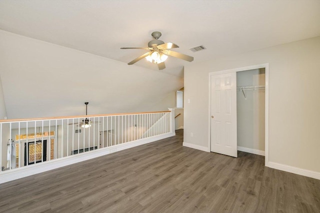 bonus room featuring visible vents, wood finished floors, baseboards, lofted ceiling, and ceiling fan