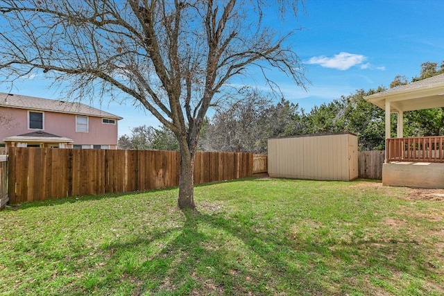 view of yard featuring an outdoor structure, a storage unit, and a fenced backyard