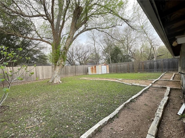 view of yard featuring a fenced backyard, a storage shed, and an outdoor structure