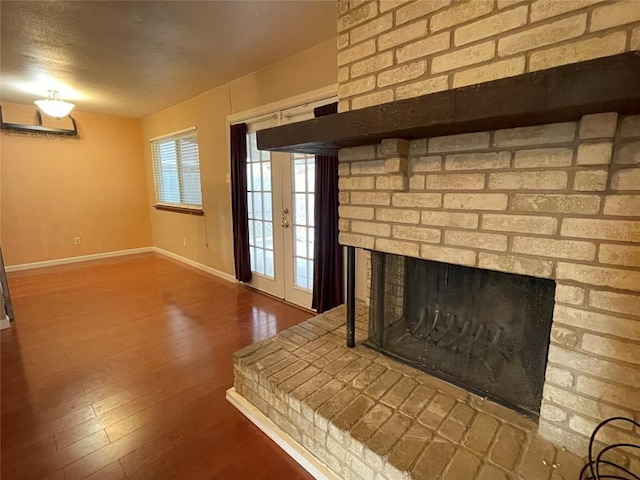 details with wood finished floors, a fireplace, and baseboards