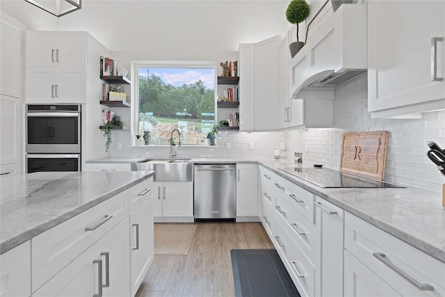 kitchen featuring open shelves, a sink, white cabinets, appliances with stainless steel finishes, and under cabinet range hood