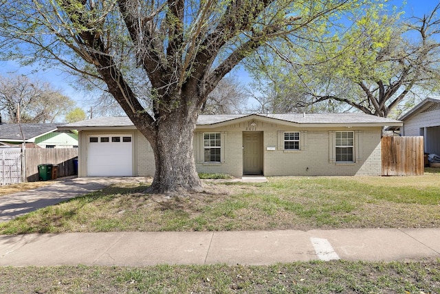 ranch-style house with brick siding, an attached garage, a front lawn, and fence