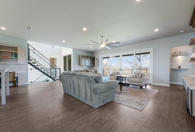 living room featuring ceiling fan, stairway, dark wood-style floors, and recessed lighting