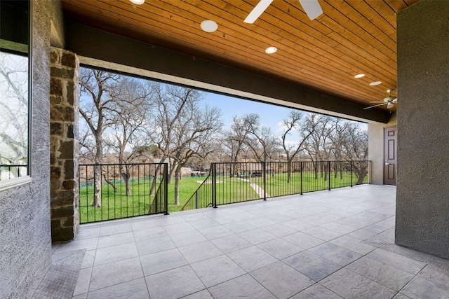 view of patio / terrace with a ceiling fan and fence