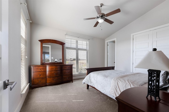 carpeted bedroom with vaulted ceiling and ceiling fan