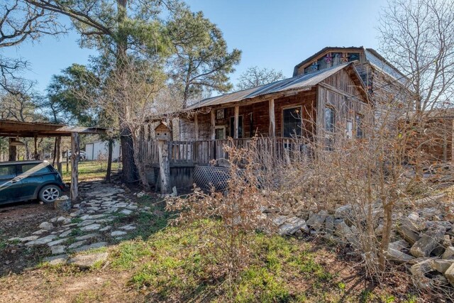 view of property exterior with a porch
