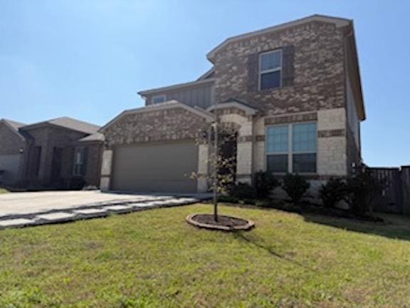 view of front facade featuring concrete driveway, an attached garage, and a front lawn