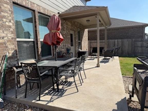 view of patio / terrace featuring outdoor dining area and fence