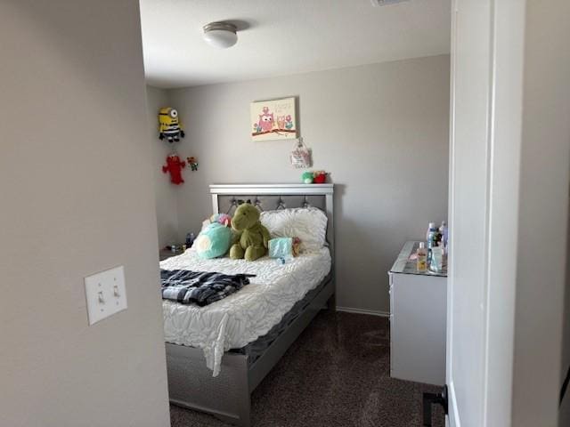 bedroom featuring visible vents and dark carpet