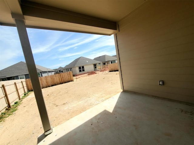 view of patio featuring a fenced backyard and a residential view