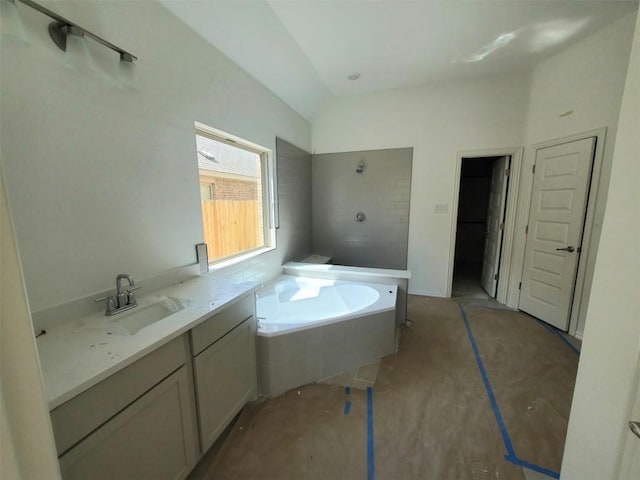 full bath featuring vanity, vaulted ceiling, a bath, and tiled shower