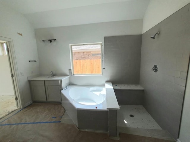 full bath featuring vanity, a bath, and tiled shower