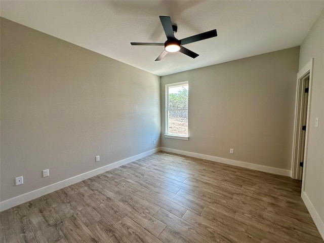 15 Persimmon Dr, Wimberley, TX 78676 - spare room featuring ceiling fan, wood finished floors, and baseboards