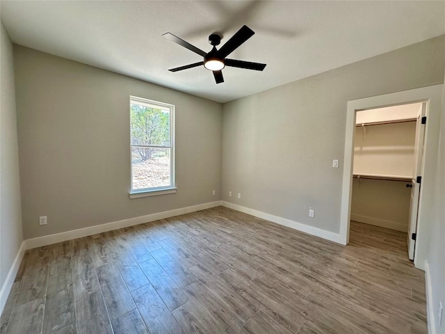 15 Persimmon Dr, Wimberley, TX 78676 - empty room featuring a ceiling fan, wood finished floors, and baseboards
