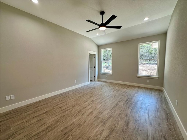 15 Persimmon Dr, Wimberley, TX 78676 - unfurnished room with wood finished floors, a ceiling fan, baseboards, recessed lighting, and lofted ceiling