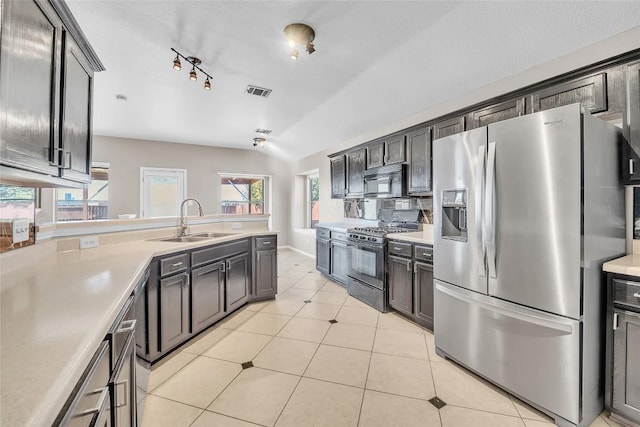 kitchen with visible vents, stainless steel fridge with ice dispenser, a sink, black microwave, and range with gas cooktop