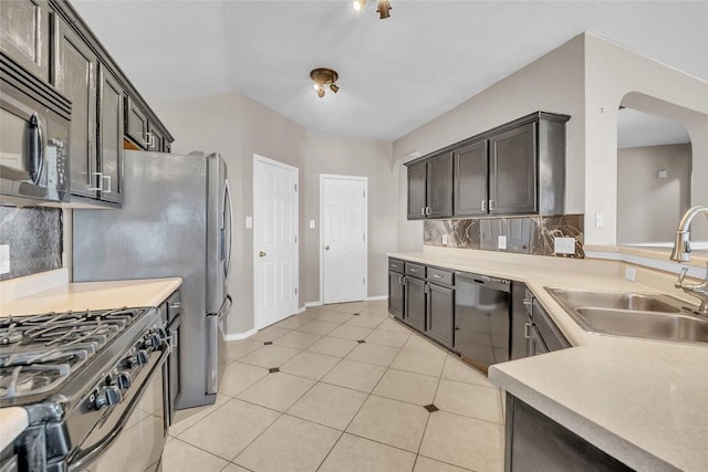 kitchen with tasteful backsplash, range with gas cooktop, light countertops, black dishwasher, and a sink