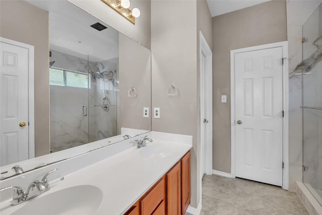 full bathroom featuring a shower stall, double vanity, baseboards, and a sink