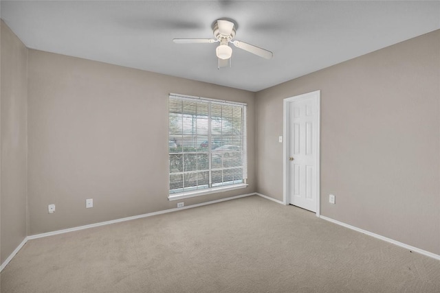 spare room with baseboards, carpet floors, and a ceiling fan