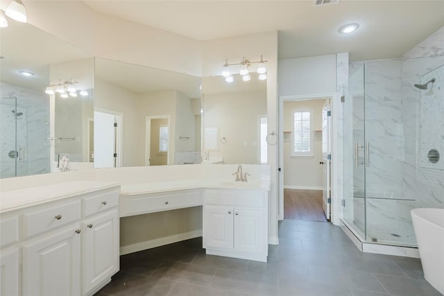 bathroom with vanity, visible vents, and a marble finish shower